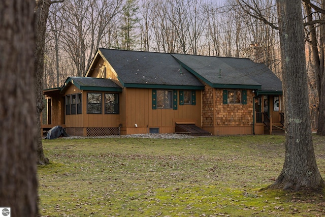 rear view of house featuring a lawn