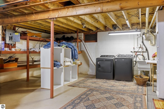 basement with electric panel, sink, and independent washer and dryer