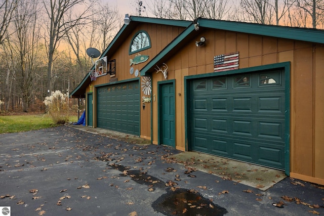 view of garage at dusk