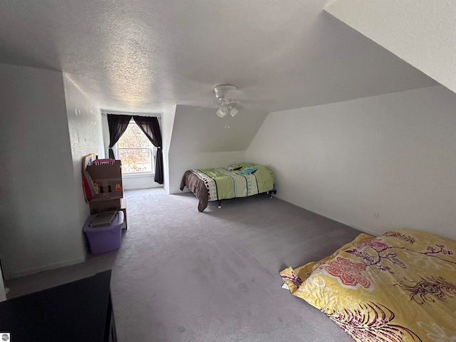 bedroom featuring ceiling fan, a textured ceiling, carpet flooring, and lofted ceiling