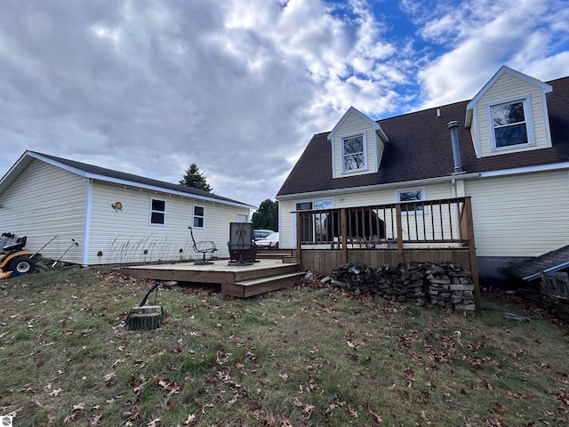 back of house with a wooden deck and a lawn