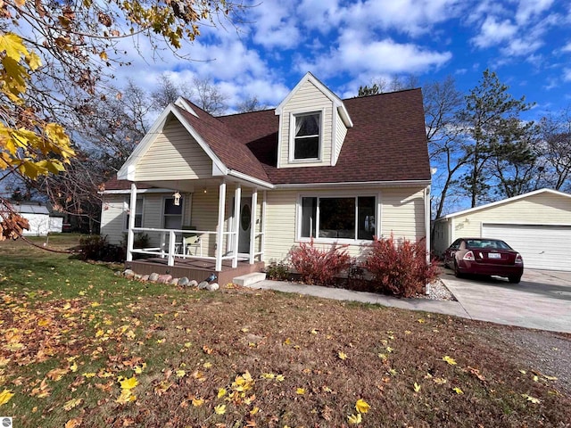 cape cod house with a garage, a front yard, covered porch, and an outbuilding