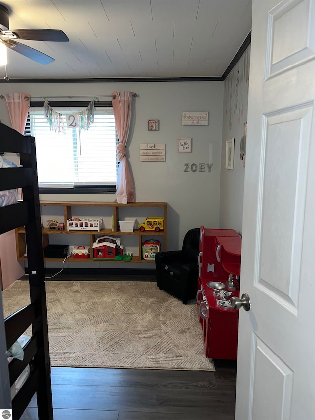 bedroom featuring ornamental molding, wood-type flooring, and ceiling fan