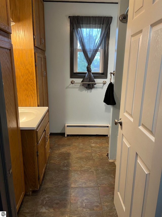 bathroom with vanity and a baseboard heating unit