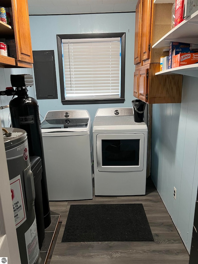 laundry area featuring washer and clothes dryer, dark hardwood / wood-style flooring, electric panel, and cabinets