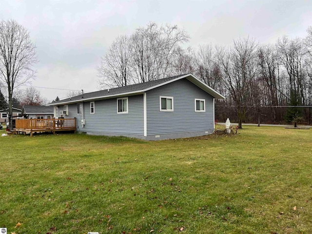 view of side of property featuring a lawn and a wooden deck