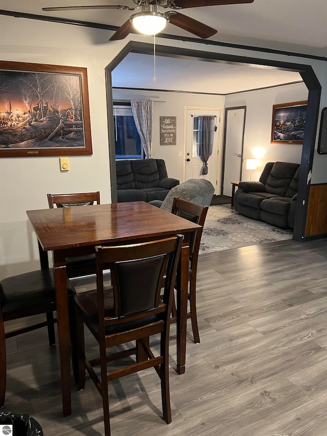 dining space with wood-type flooring and ceiling fan