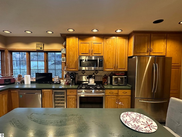 kitchen with decorative backsplash, stainless steel appliances, and beverage cooler