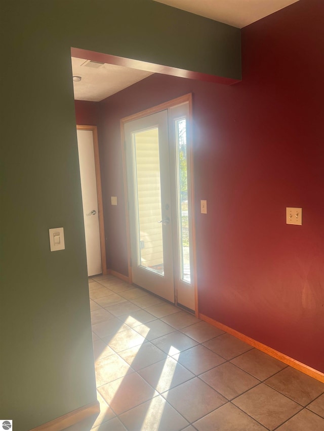 tiled spare room with a healthy amount of sunlight