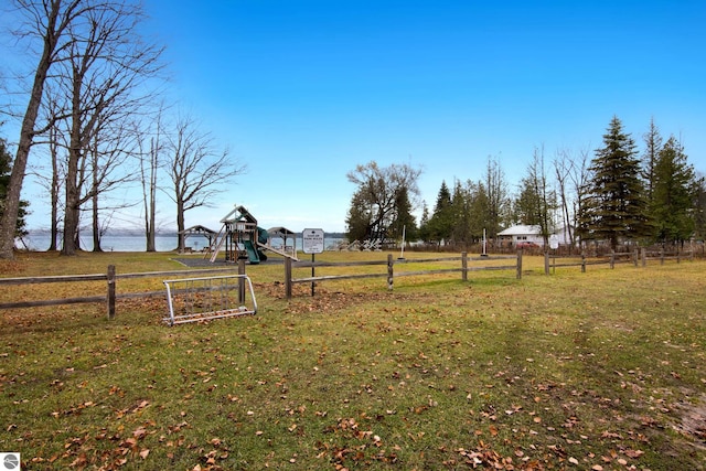 view of yard with a playground and a water view