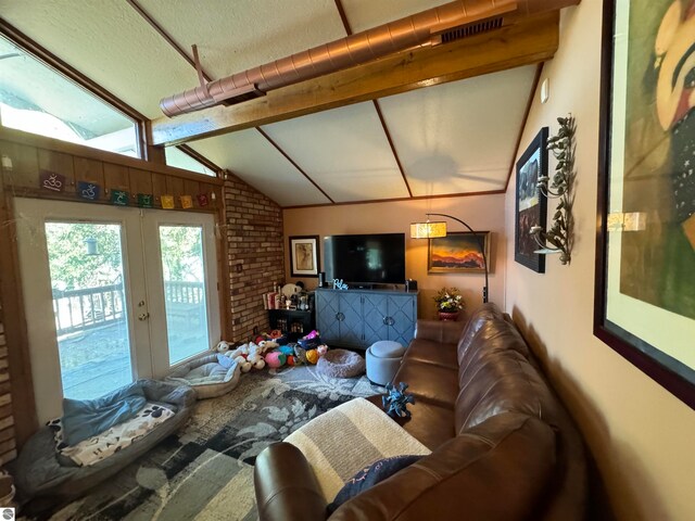 living room with french doors and lofted ceiling with beams