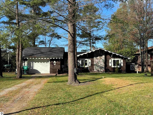 ranch-style house with a garage and a front yard