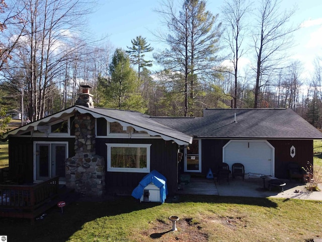 back of house with a patio and a lawn