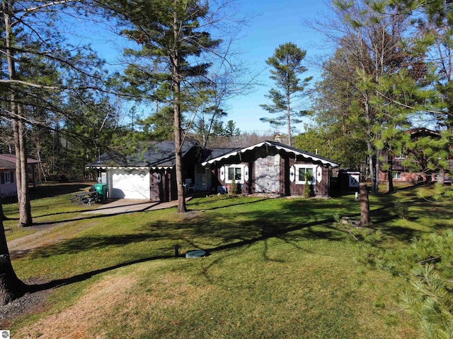 ranch-style house featuring a garage and a front yard