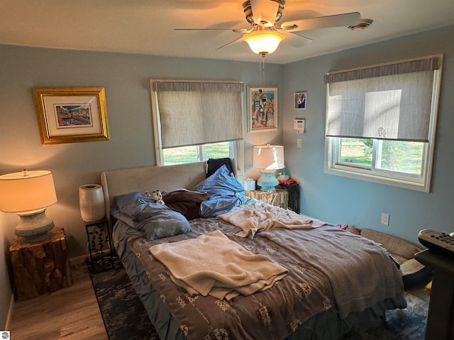 bedroom featuring hardwood / wood-style floors and ceiling fan