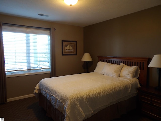 bedroom featuring dark carpet