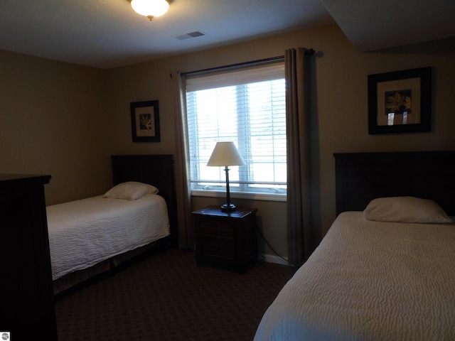 bedroom featuring dark colored carpet