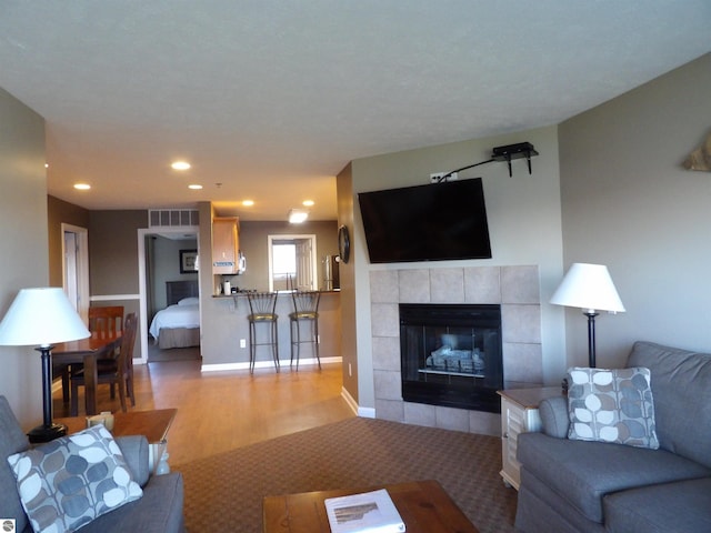 living room with light hardwood / wood-style floors and a fireplace