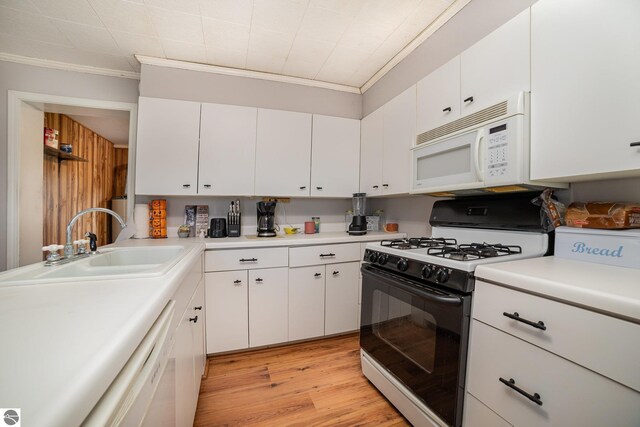 kitchen with ornamental molding, white cabinetry, sink, white appliances, and light hardwood / wood-style flooring