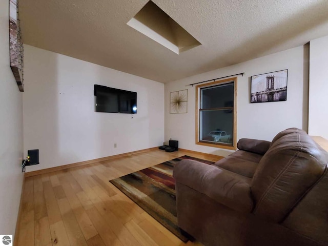 living room with hardwood / wood-style floors and a textured ceiling