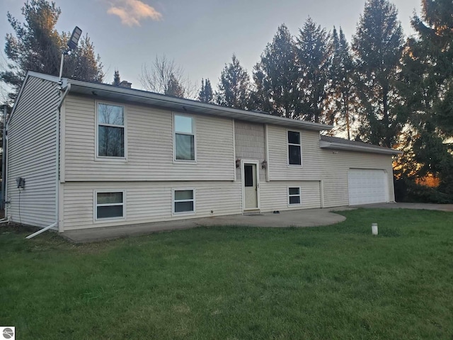 bi-level home featuring a lawn and a patio