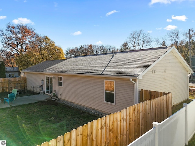 back of house featuring a patio and a yard