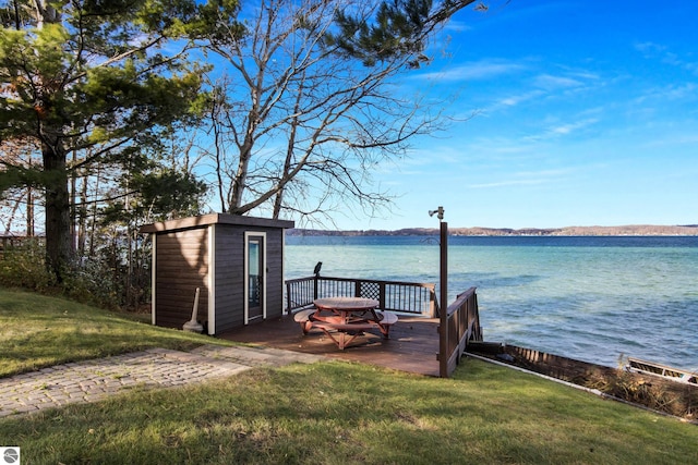 view of dock featuring a yard and a water view