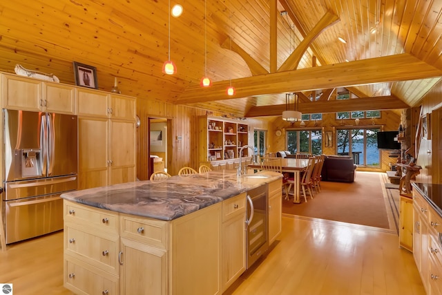 kitchen featuring sink, stainless steel fridge with ice dispenser, decorative light fixtures, a kitchen island with sink, and wood ceiling