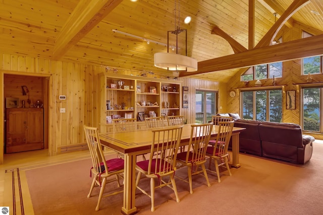 carpeted dining area featuring a healthy amount of sunlight, beam ceiling, and high vaulted ceiling