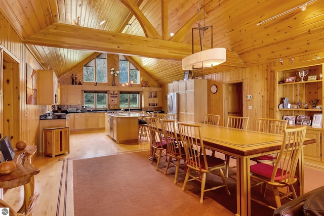 dining area featuring wooden ceiling, high vaulted ceiling, wooden walls, beamed ceiling, and light hardwood / wood-style floors