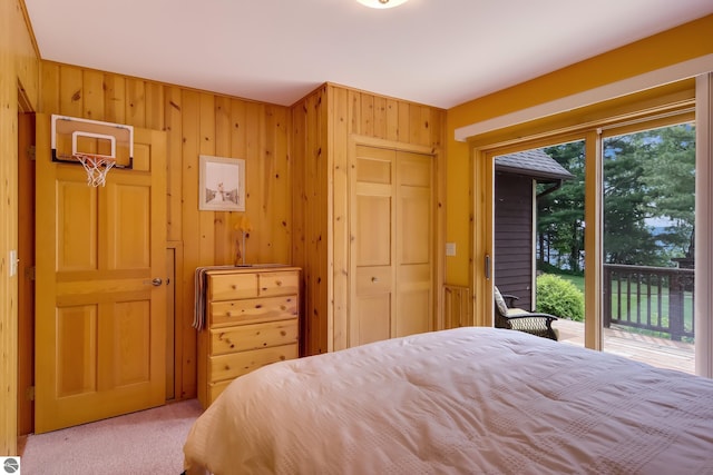 bedroom featuring access to outside, multiple windows, a closet, and carpet floors