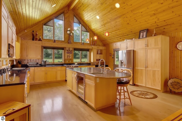 kitchen featuring stainless steel refrigerator with ice dispenser, wood ceiling, a kitchen island with sink, and sink