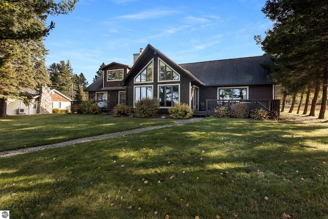 view of front of house featuring a front yard and a wooden deck