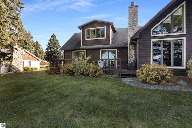 rear view of property featuring a wooden deck and a yard