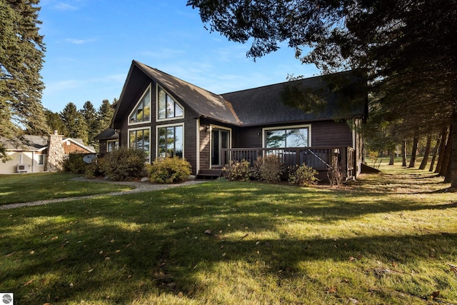 view of front facade with a wooden deck and a front lawn