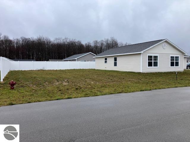 view of side of property with a yard