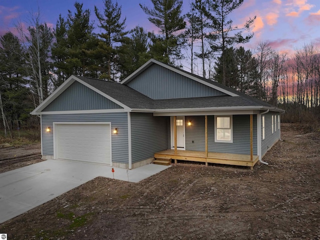 view of front of house with covered porch and a garage