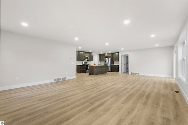 unfurnished living room with light hardwood / wood-style flooring