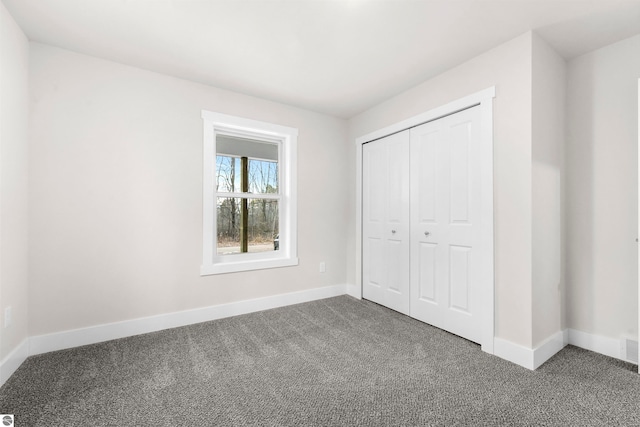 unfurnished bedroom featuring carpet and a closet