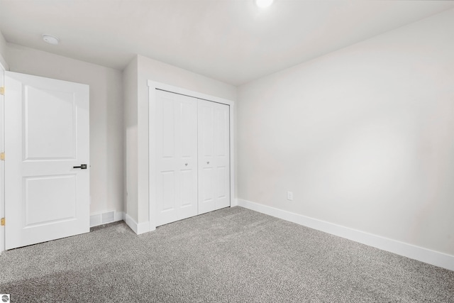 unfurnished bedroom with carpet floors and a closet