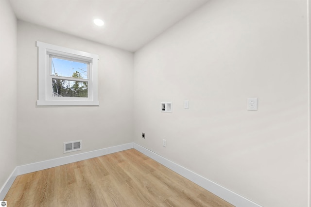 laundry room with hookup for an electric dryer, light wood-type flooring, and hookup for a washing machine