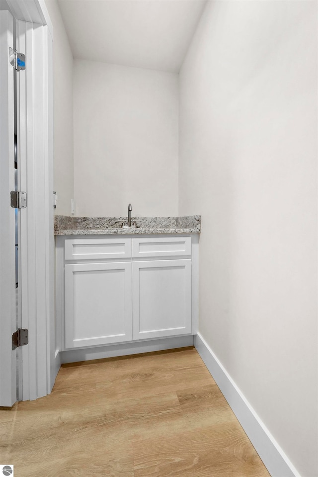 bathroom with sink and wood-type flooring