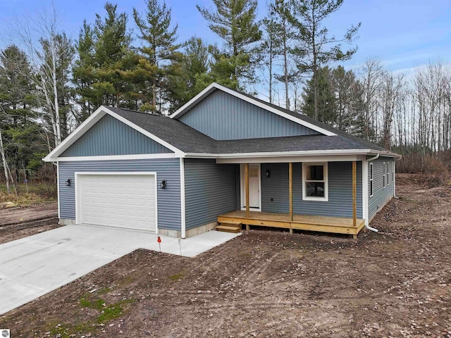 view of front of house featuring a porch and a garage