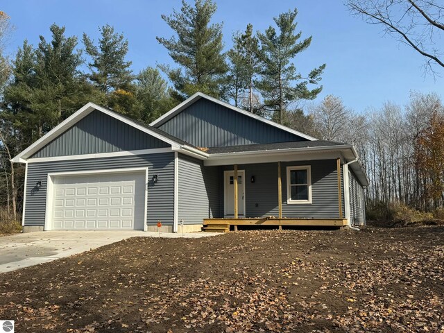 view of front of house featuring a porch and a garage