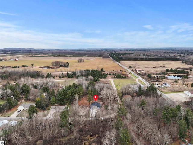 birds eye view of property featuring a rural view and a water view