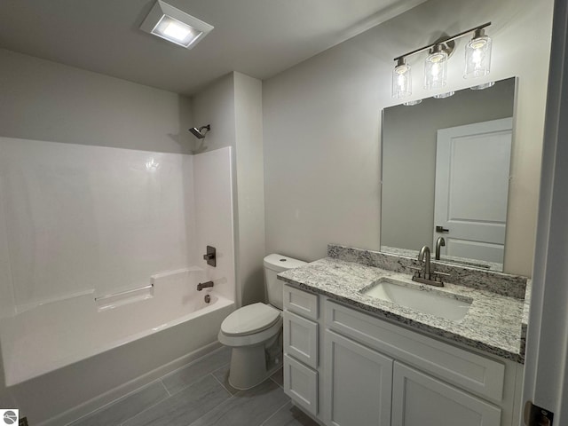 full bathroom featuring shower / bathing tub combination, vanity, and toilet