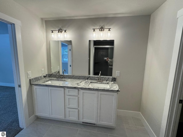 bathroom with tile patterned floors and vanity