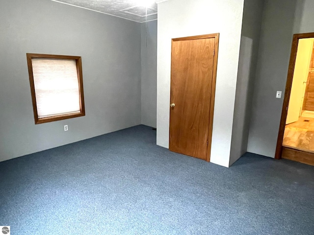 unfurnished bedroom featuring dark colored carpet