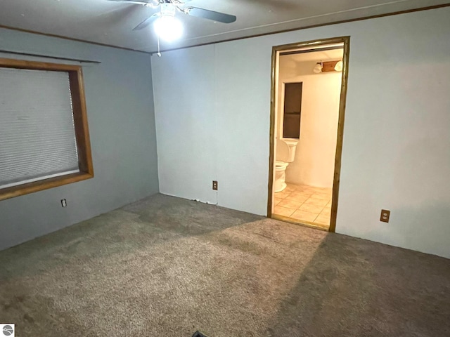 spare room featuring ceiling fan and carpet