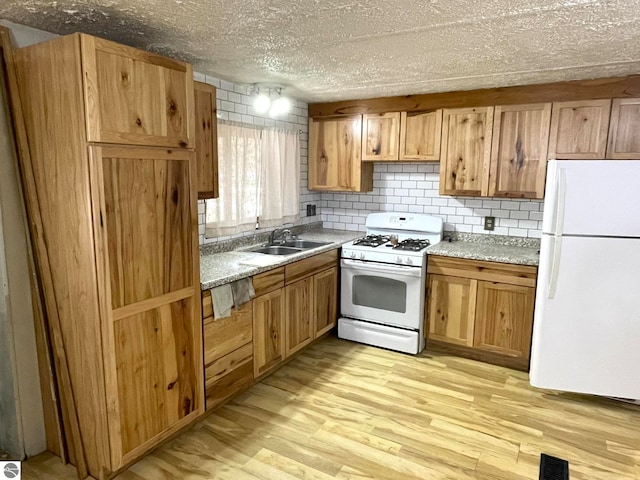 kitchen featuring light hardwood / wood-style flooring, sink, decorative backsplash, white appliances, and light stone countertops